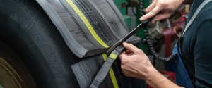 Tire tread being fitted to prepared surface